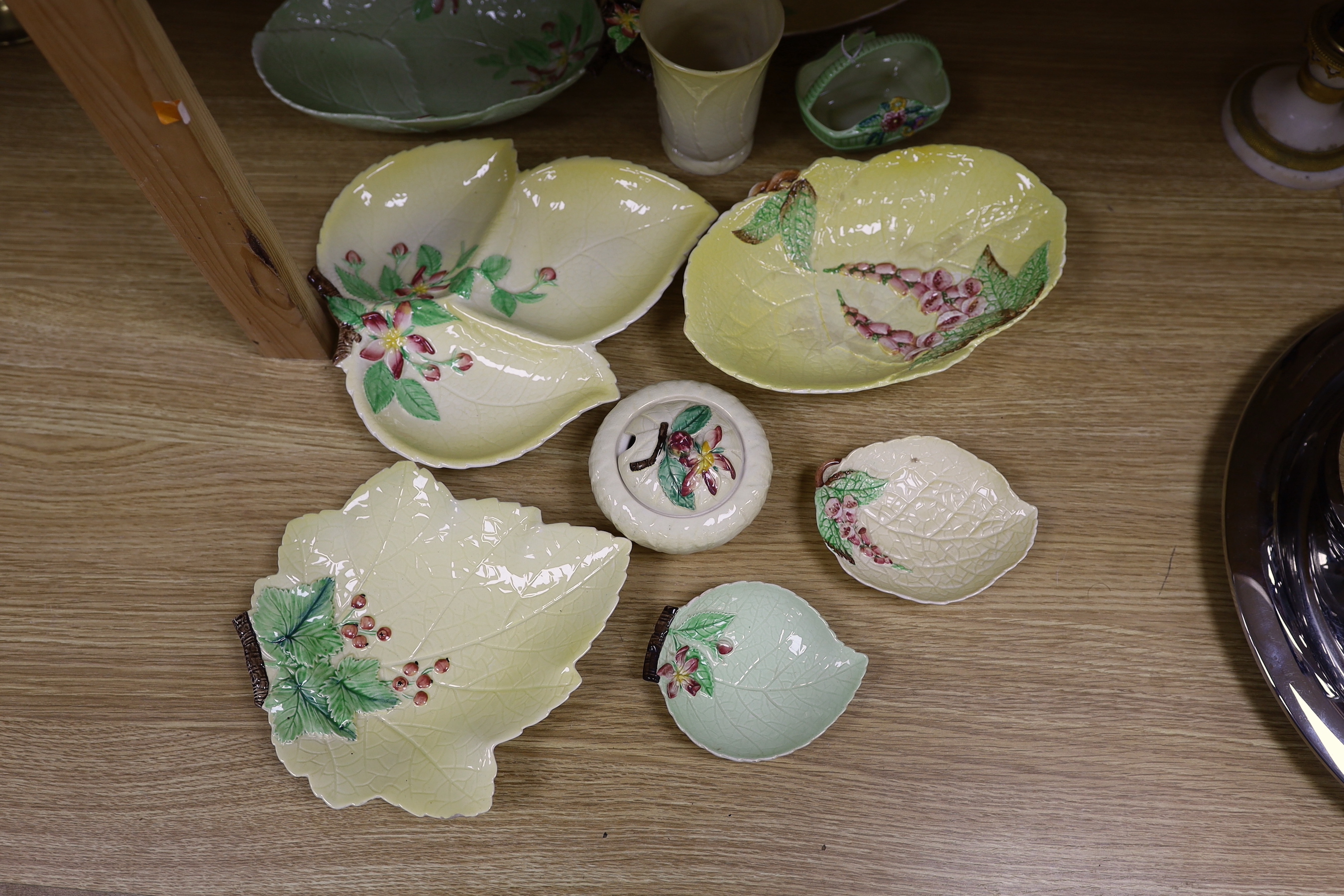 A collection of Carlton Ware leaf moulded dishes, a cup and a preserve pot and cover